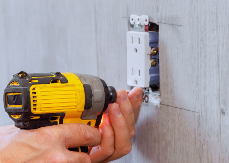 Electrical-Outlet-replacement Handyman installing a new power outlet