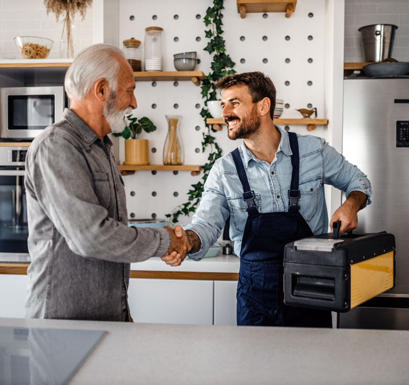 Handyman-and-client Handyman Shaking a clients hand before starting the job