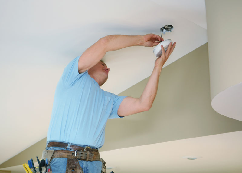 Smoke-Detector-repair Handyman installing a smoke detector